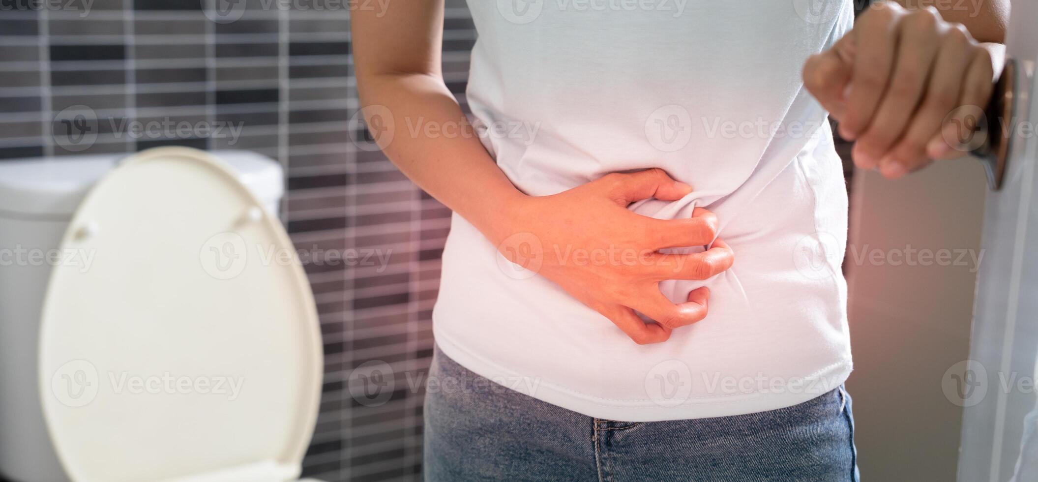 diarrhea in bathroom. female touch belly stomach ache painful. colon inflammation problem, toxic food, abdominal pain, abdomen, constipated in toilet, stomachache, Hygiene photo