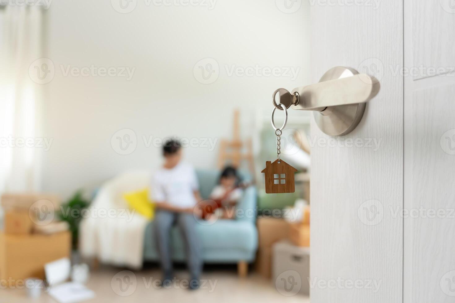 Moving house, relocation and Open the door found Family smile and play on new house, inside the room was a cardboard box contain personal belongings and furniture. move in the new apartment or home. photo