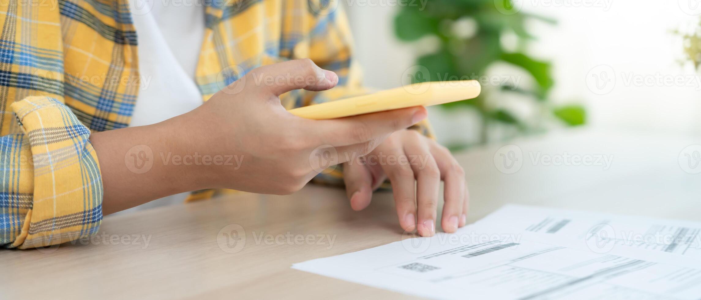 woman use phone to scan barcode or QR codes to pay credit card bill after receive document invoice. payment, receive, paying electricity, digital payments without money, technology, scanning photo