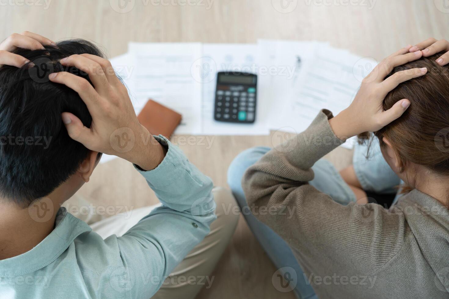 Stressed and headache asian couple with large bills or invoices no money to pay to expenses and business problem. shortage, Financial problems, mortgage, bankruptcy, bankrupt, poor photo