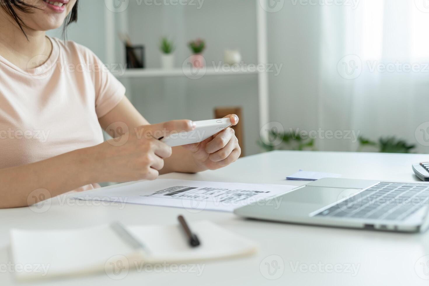 Modern women use phone scan barcode or QR codes to pay credit card bill after receive document invoice. payment, receive, paying electricity, digital payments without money, technology, scanning photo