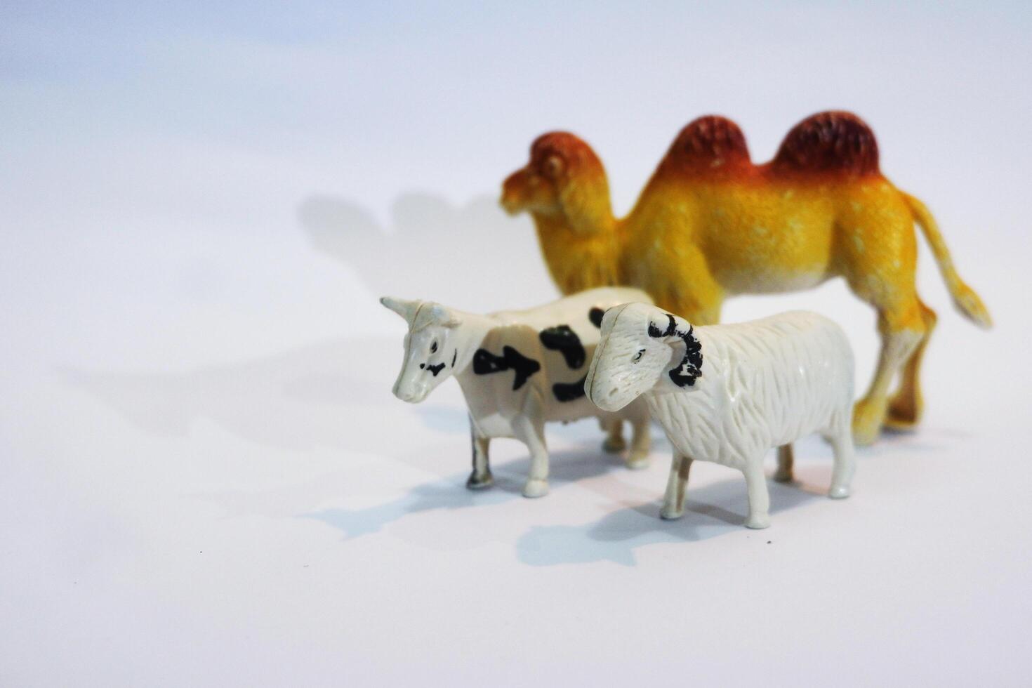 A toy camel and a toy sheep photo