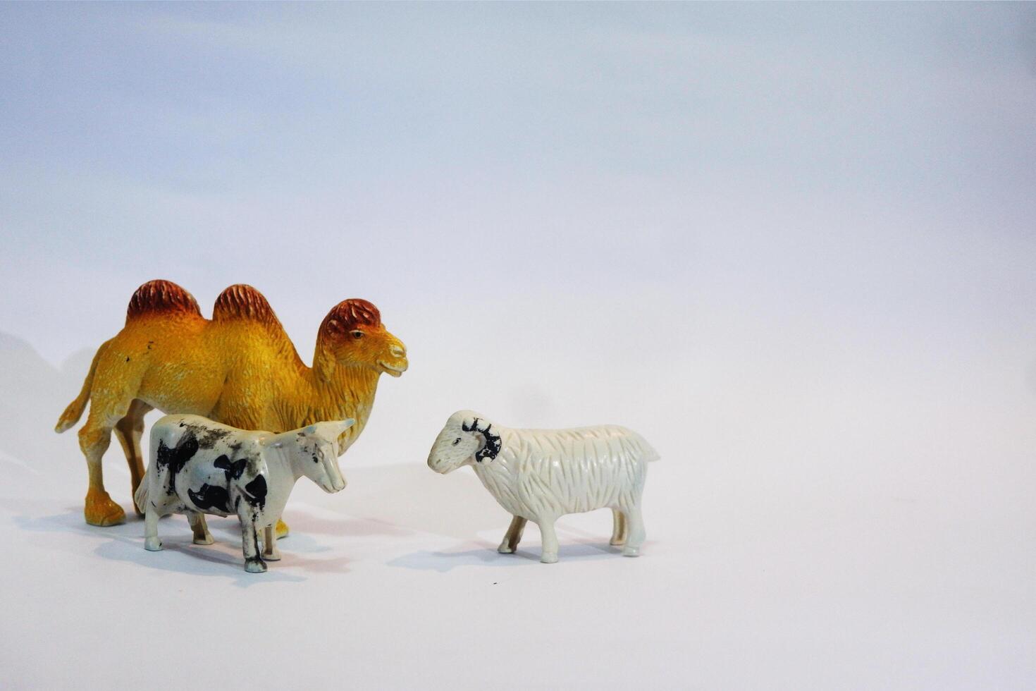 A toy camel and a toy goat photo