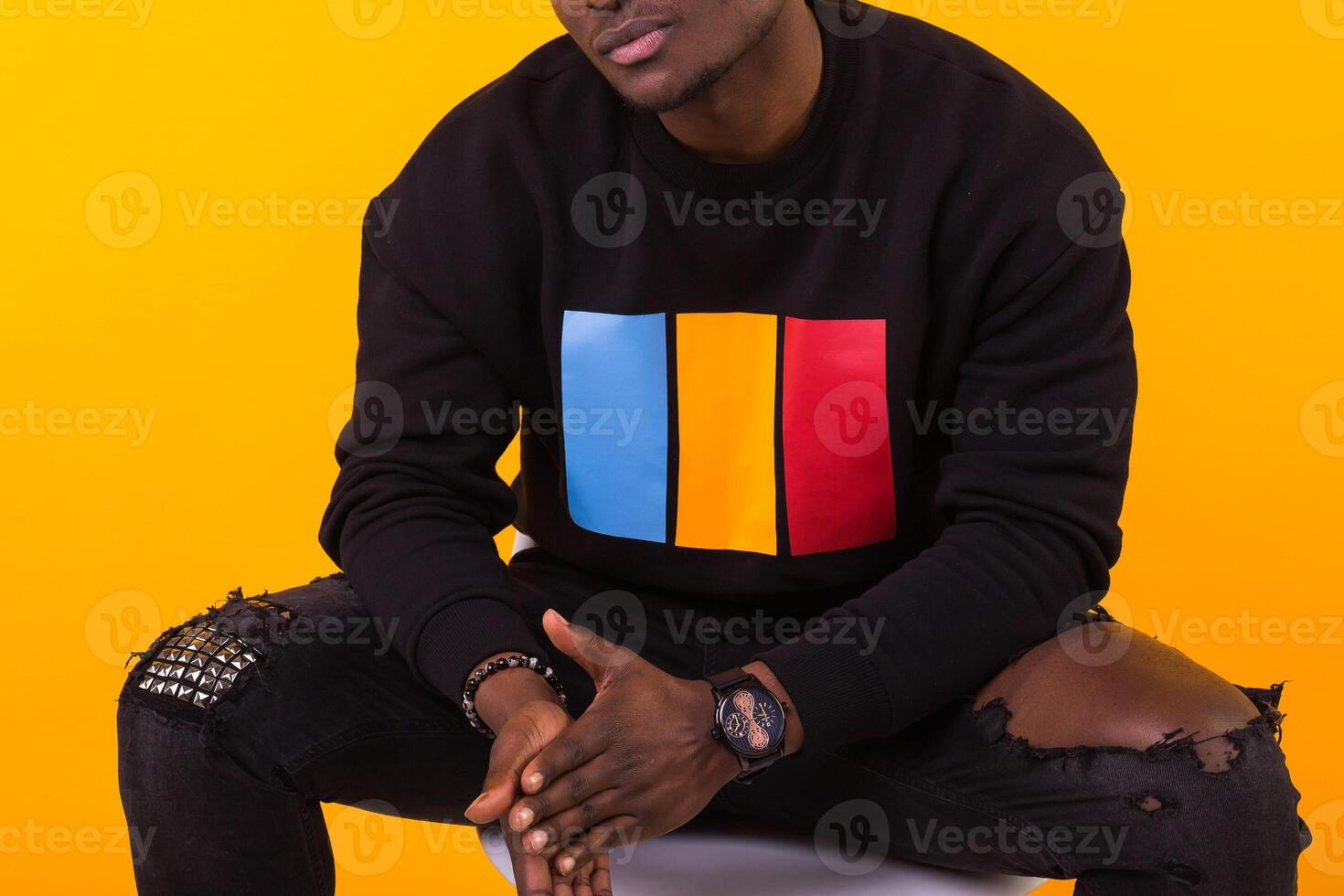 Close-up of african american man with an afro hairstyle. on yellow background. Guy looking at camera. photo