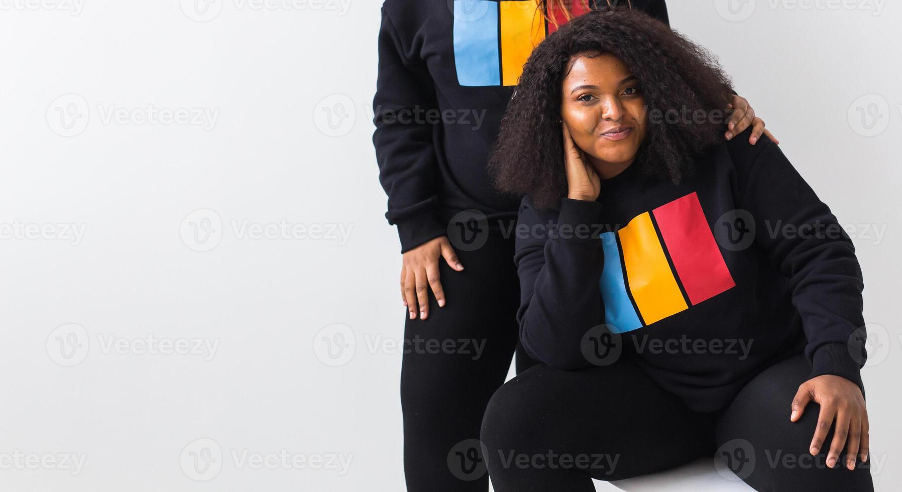 Happy African American woman and her friend on white background with copy space. photo
