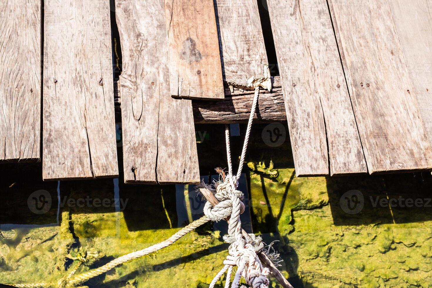 harbor quayside with rusted bollard rope photo