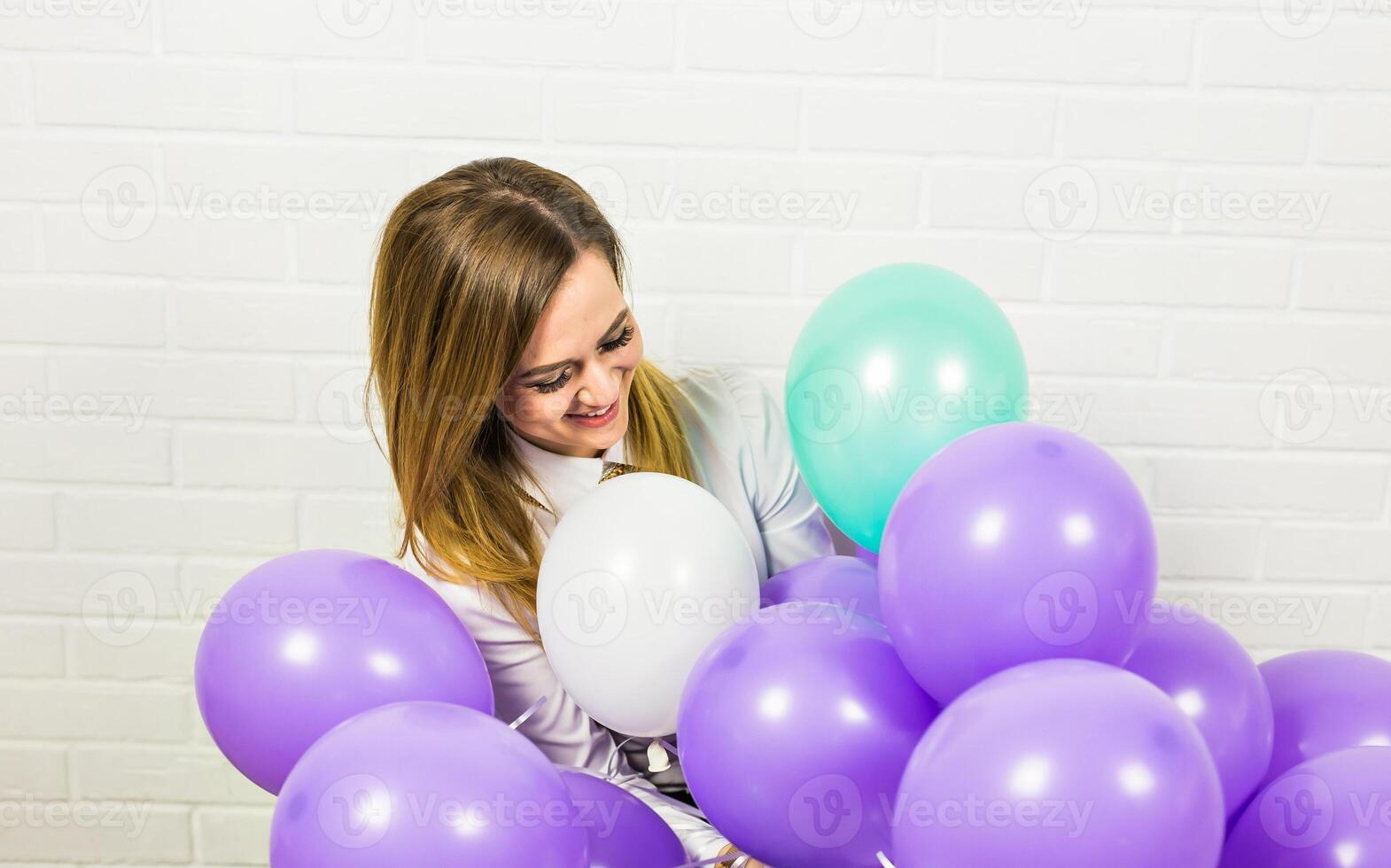 holidays, celebration and lifestyle concept - beautiful woman with colorful balloons indoors photo