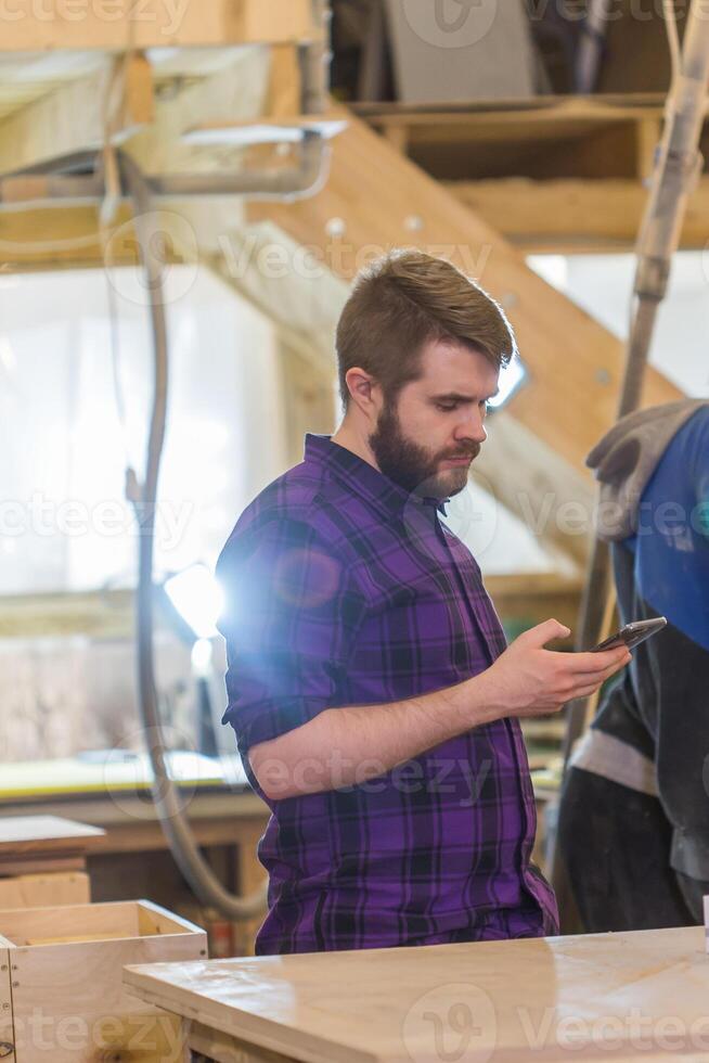 Young handsome man using a smartphone, tapping the screen - technology, social network, communication concept. photo