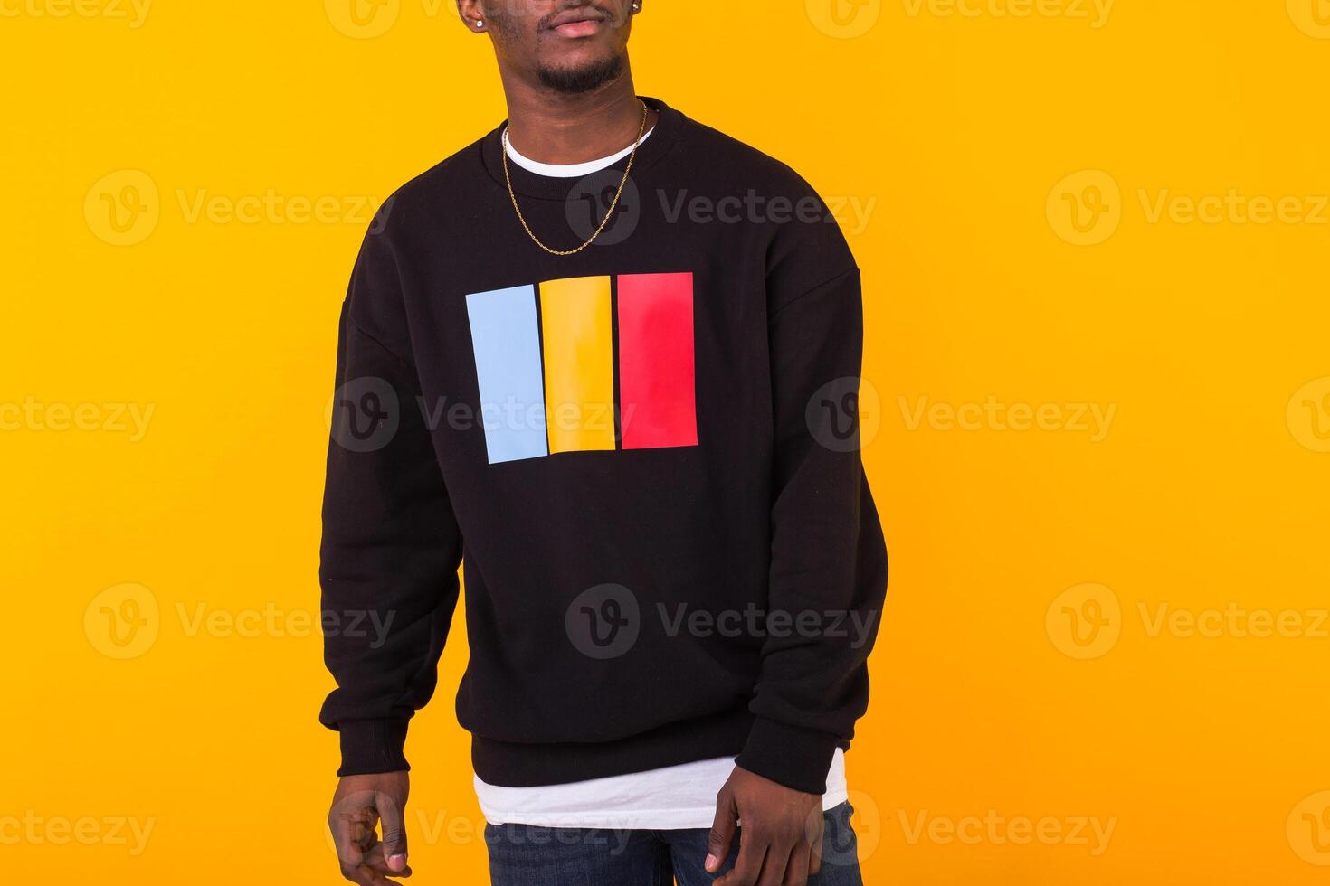 Young handsome african american man with an afro hairstyle. Portrait on yellow background with copy space. Guy looking at camera. photo