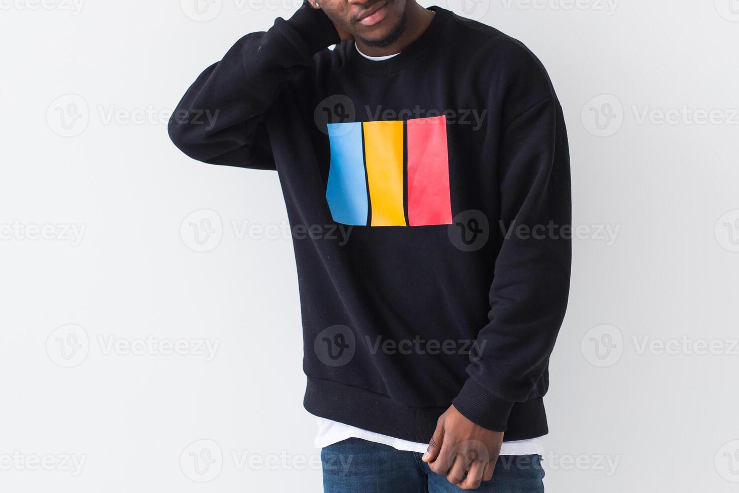 Street fashion concept - Studio shot of young handsome African man wearing sweatshirt against white background, close-up. photo