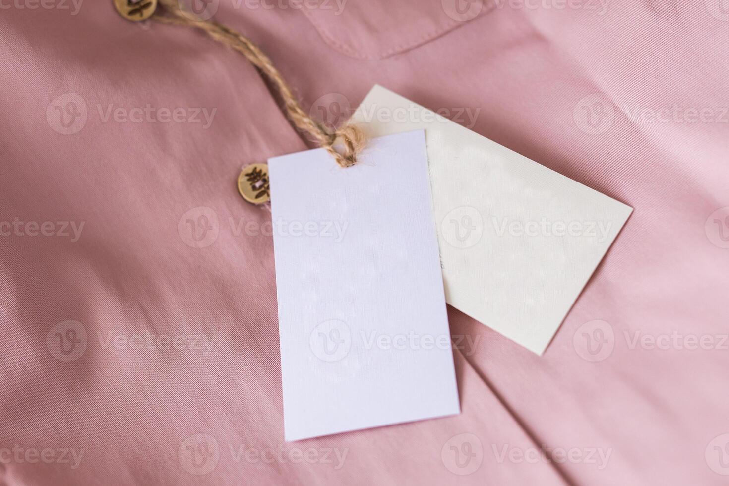 Close-up blank tag label on pink shirt. Copy space and space for advertisement. photo