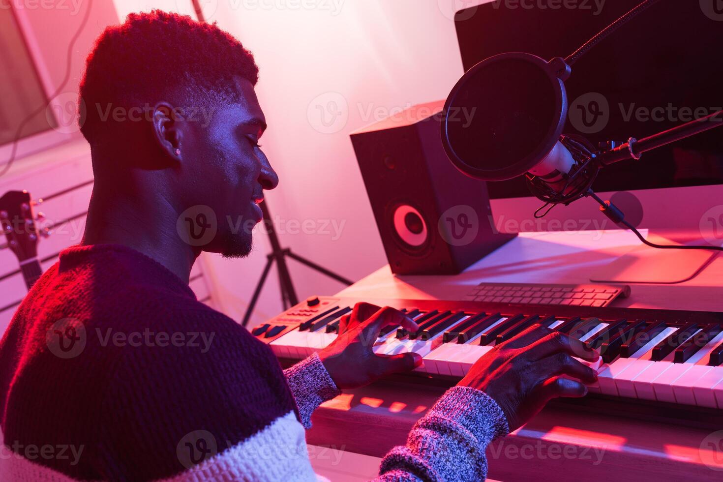 Music production concept - Male sound producer working in home recording studio, close-up. photo