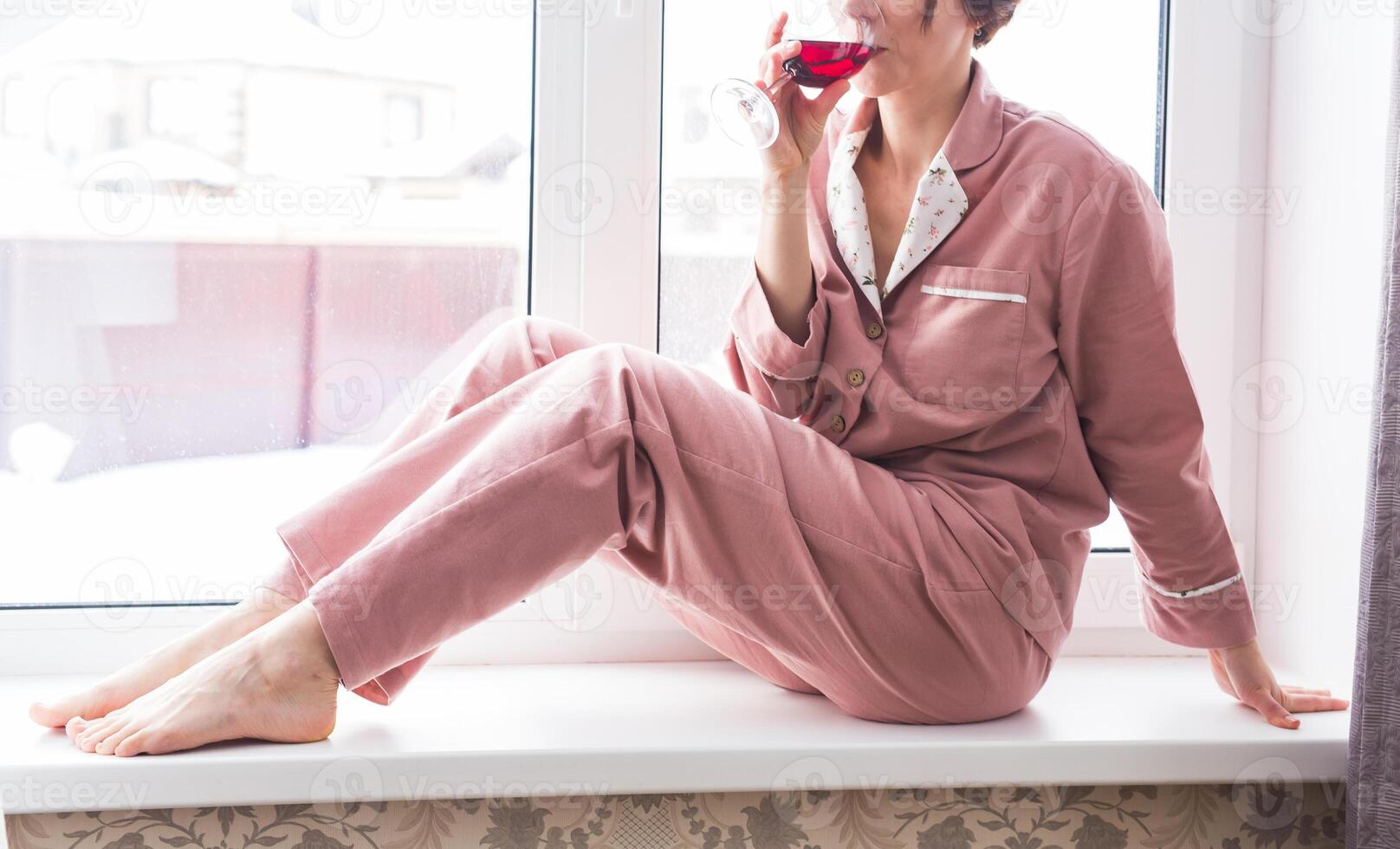 Close-up woman relaxing with red wine at home. photo