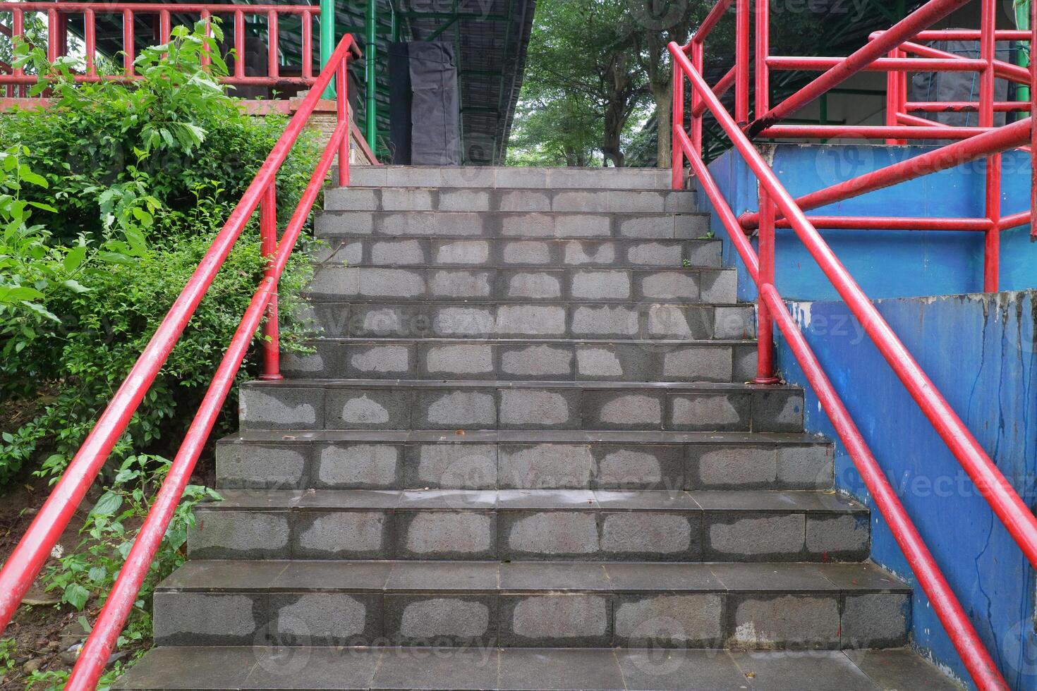 Concrete Stairs with Red Handrails in Outdoor Public Area photo