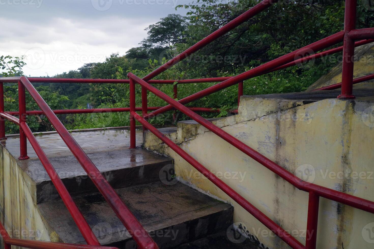 Concrete Stairs with Red Handrails After Rain photo