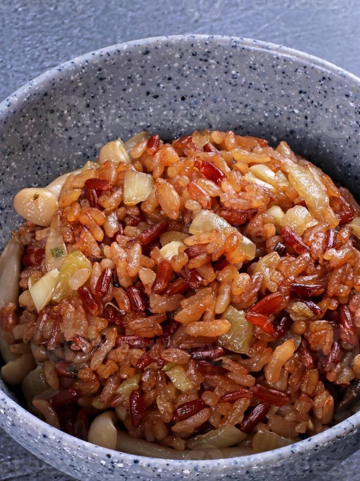a bowl of rice and beans with a spoon photo