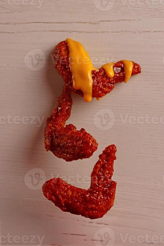 a piece of hot dog with cheese on it photo