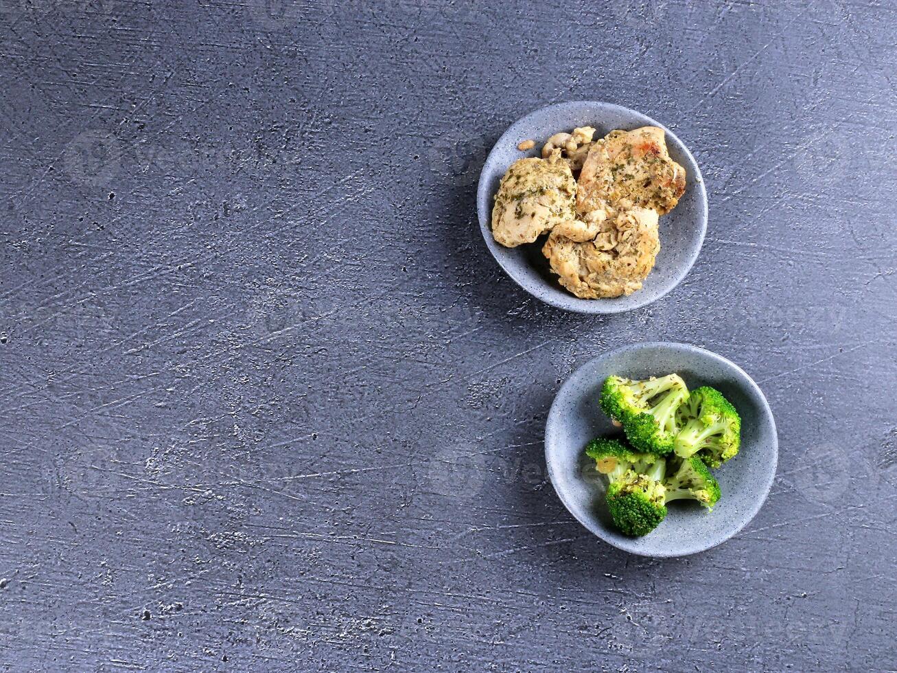 two plates of broccoli and a bowl of chicken photo