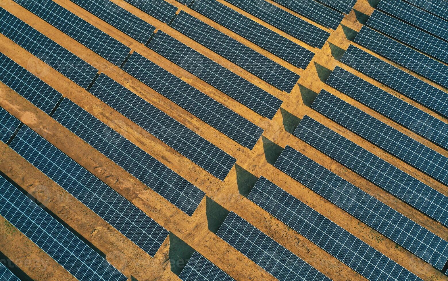 Aerial view of rows of solar panels installed on a vast field. photo
