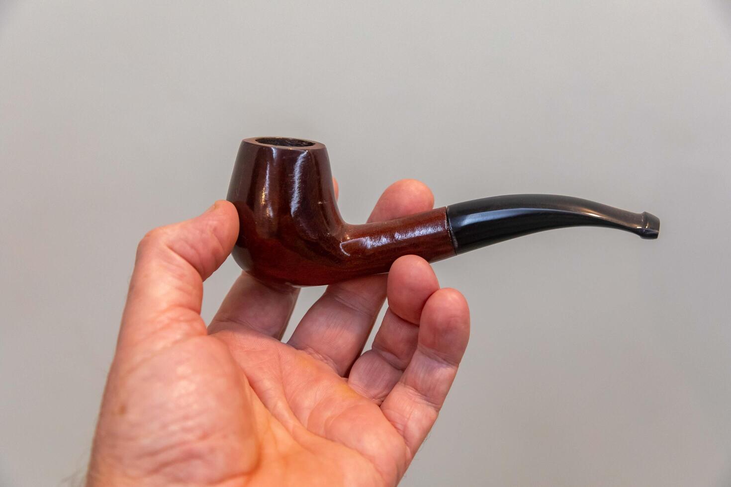 Hand holding luxurious pipe in selective focus and smooth background POPYE photo
