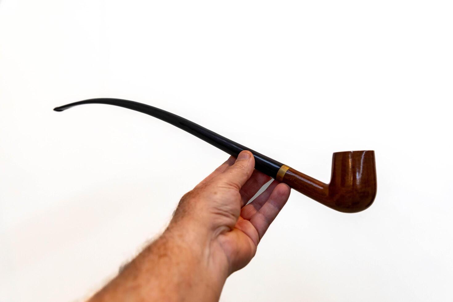 Hand holding luxurious pipe in selective focus and smooth background 5 photo