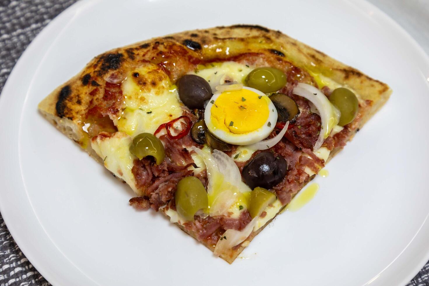 Original Brazilian pizza with olives, mushrooms, grated pepperoni, onion, red pepper, oregano and extra virgin olive oil egg photo