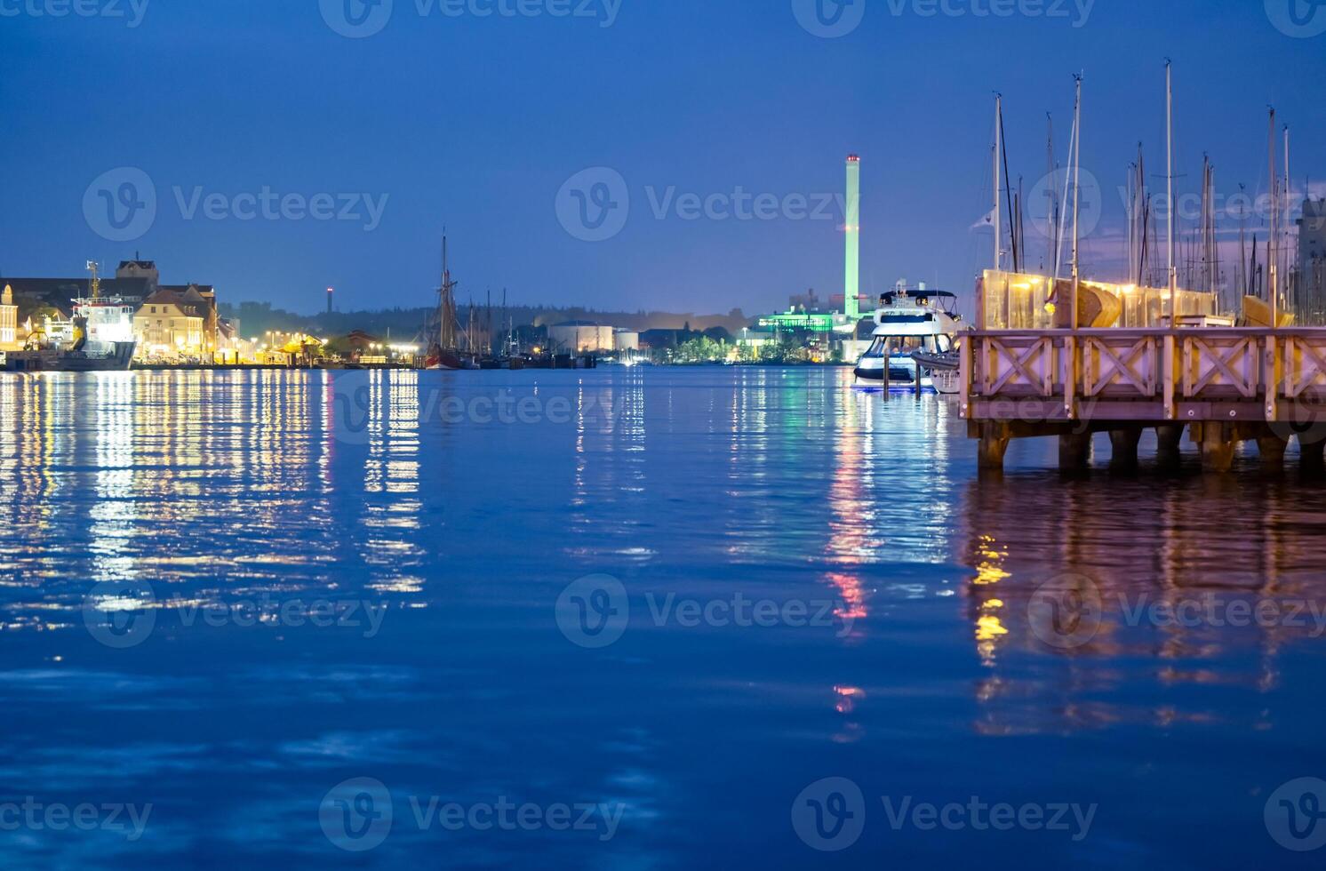 Dusk Waterfront Scene with City Lights and Boats photo