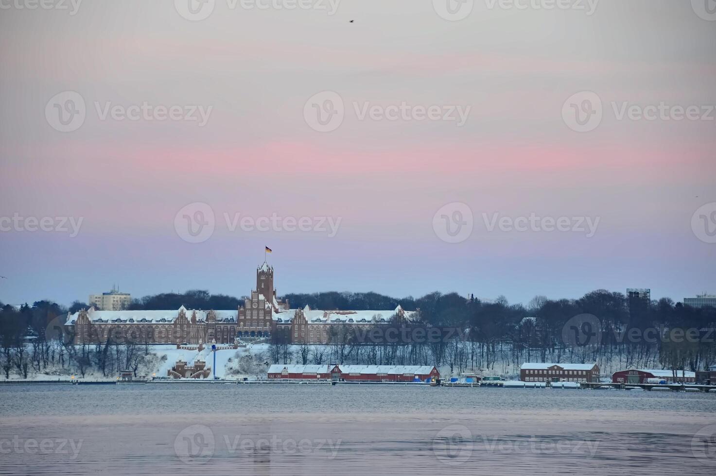 Winter Landscape with Historic Building and Calm Waters photo