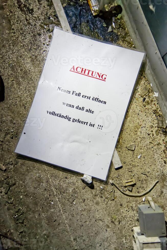 Warning Sign on the Ground in a Messy Area photo