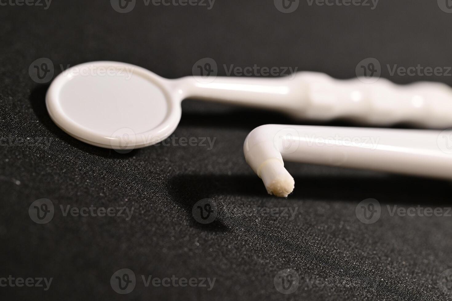 Close-up of Dental Tools on Black Surface photo