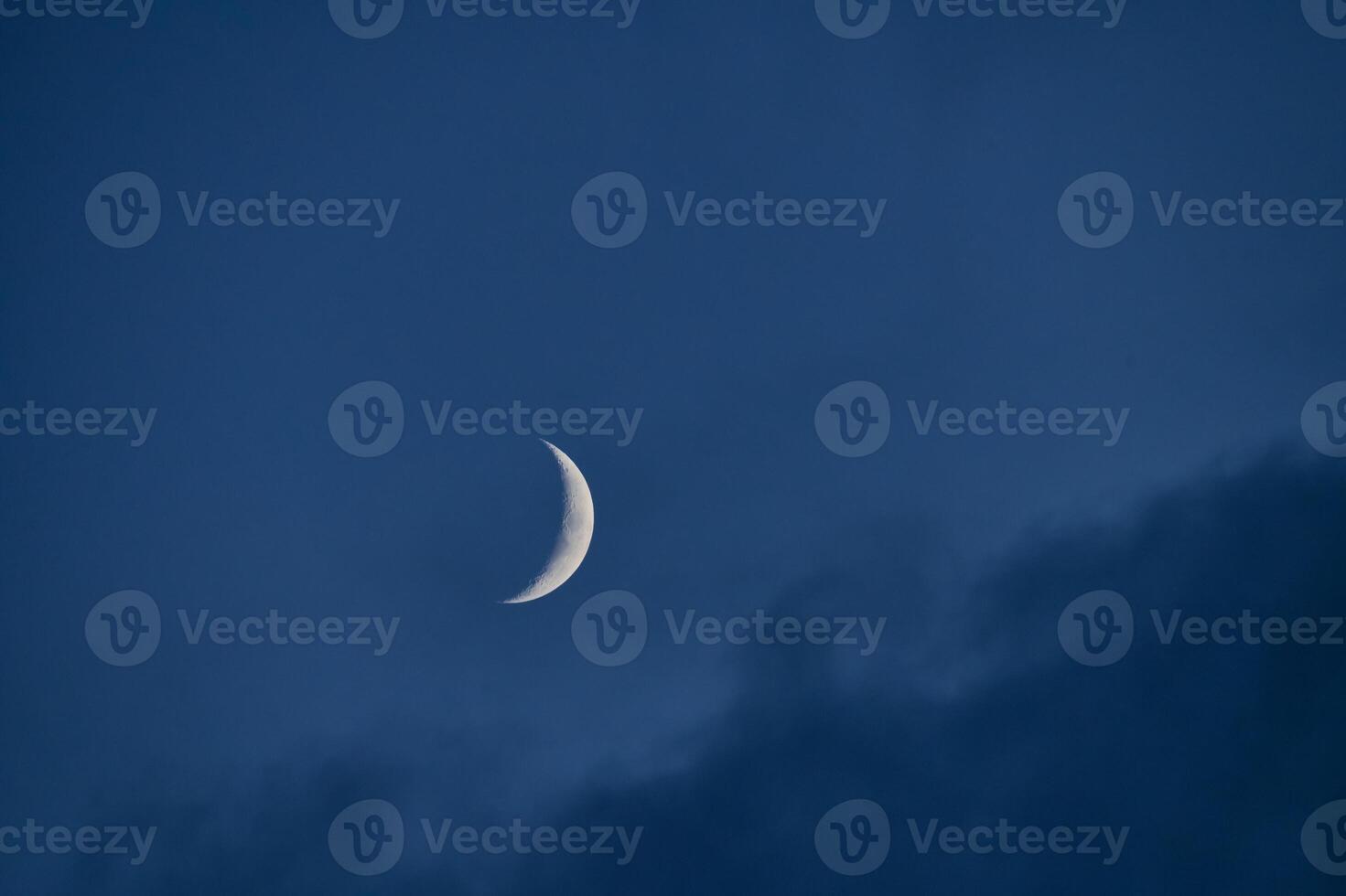 Crescent Moon in a Dark Blue Sky photo