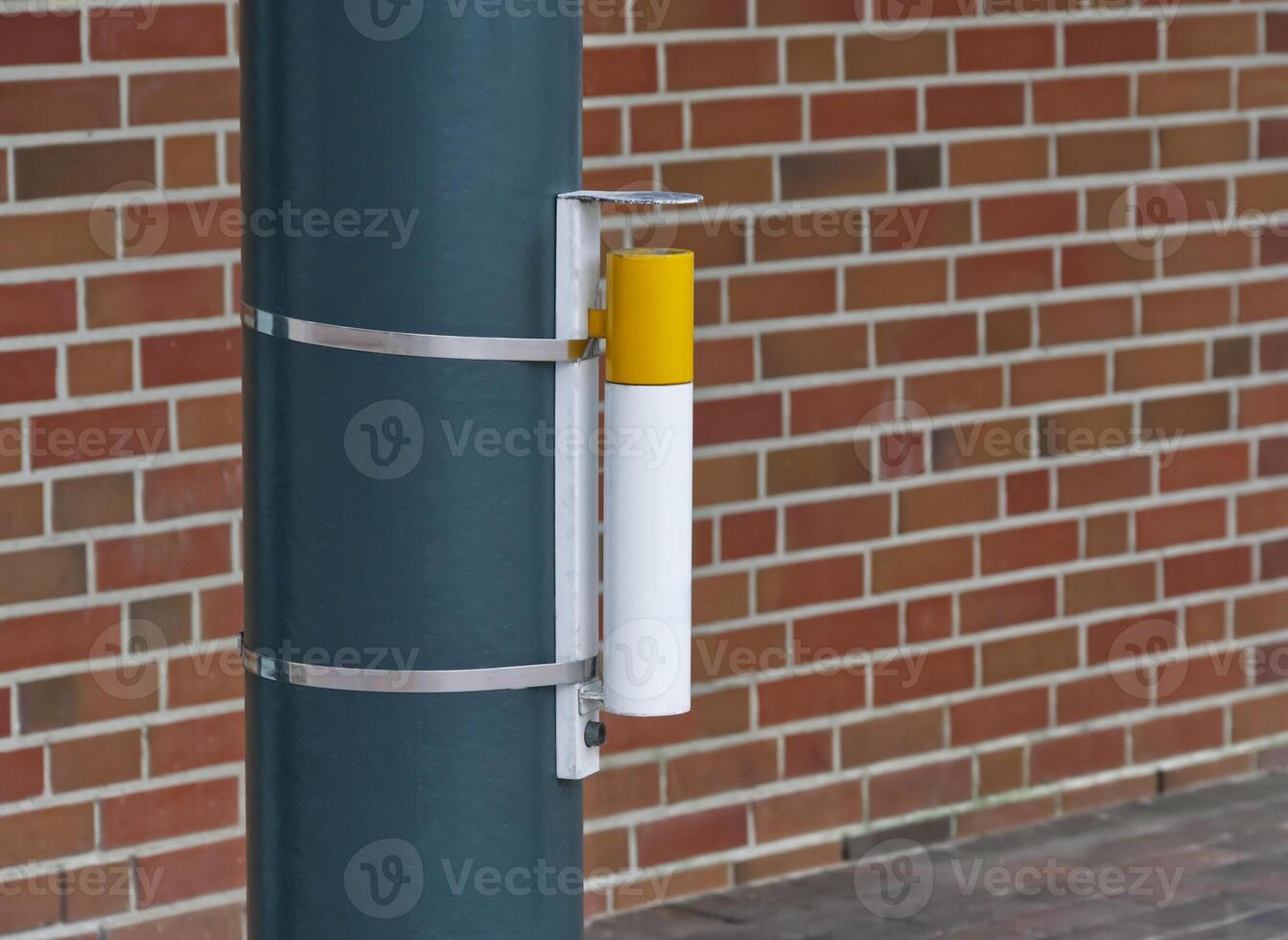 At the Harrislee market square, a cigarette shaped ashtray is attached to a pole photo