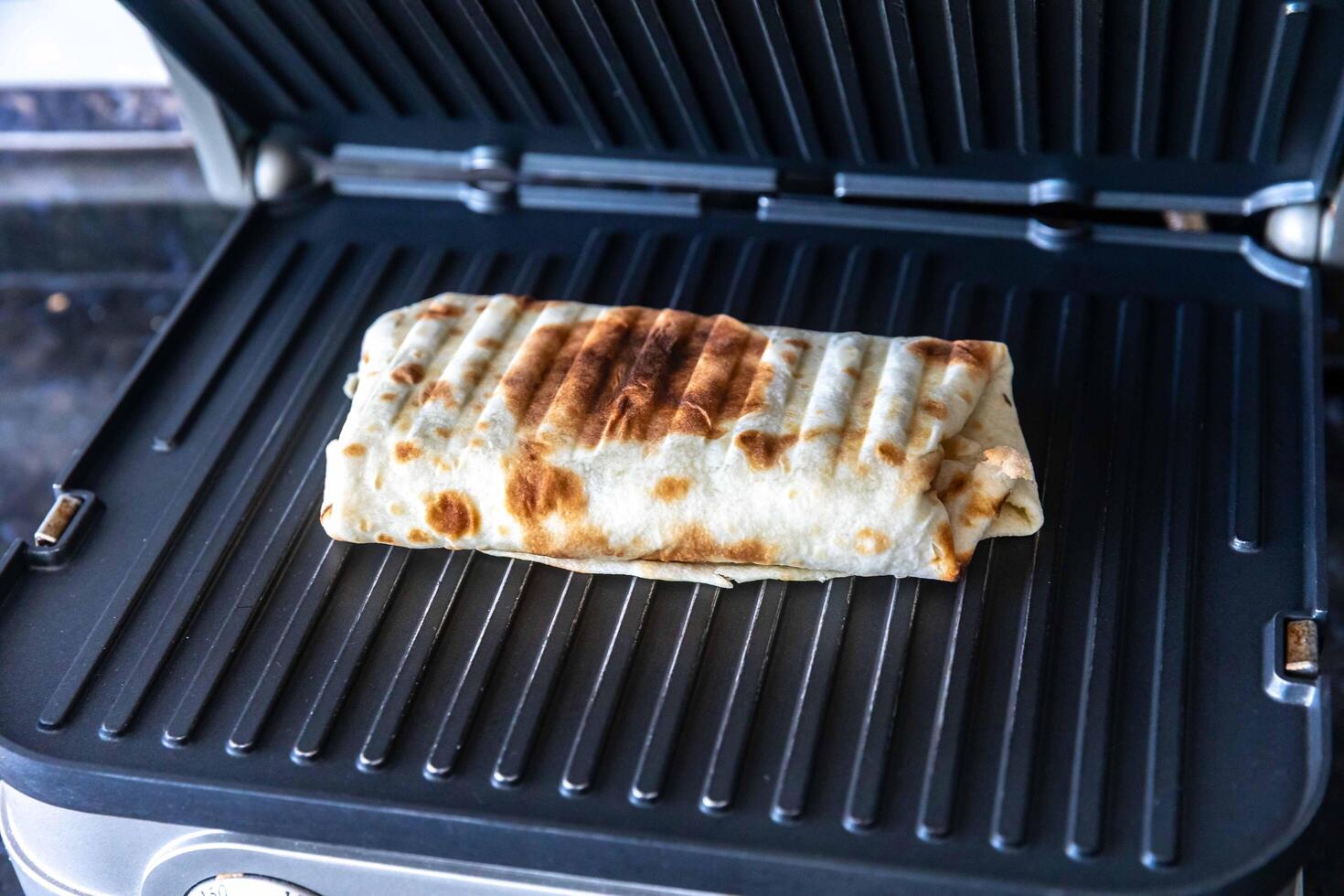 Close-up of a delicious shawarma wrap held in hand photo