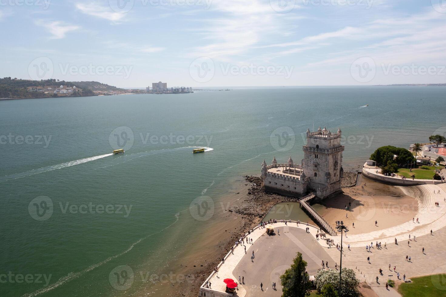 Belem Tower on Tagus River with boats creating wakes photo