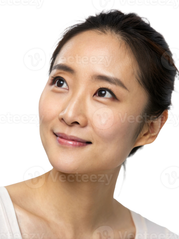 A serene young Asian woman gazes upwards with a gentle smile, showcasing natural beauty and glowing skin. png