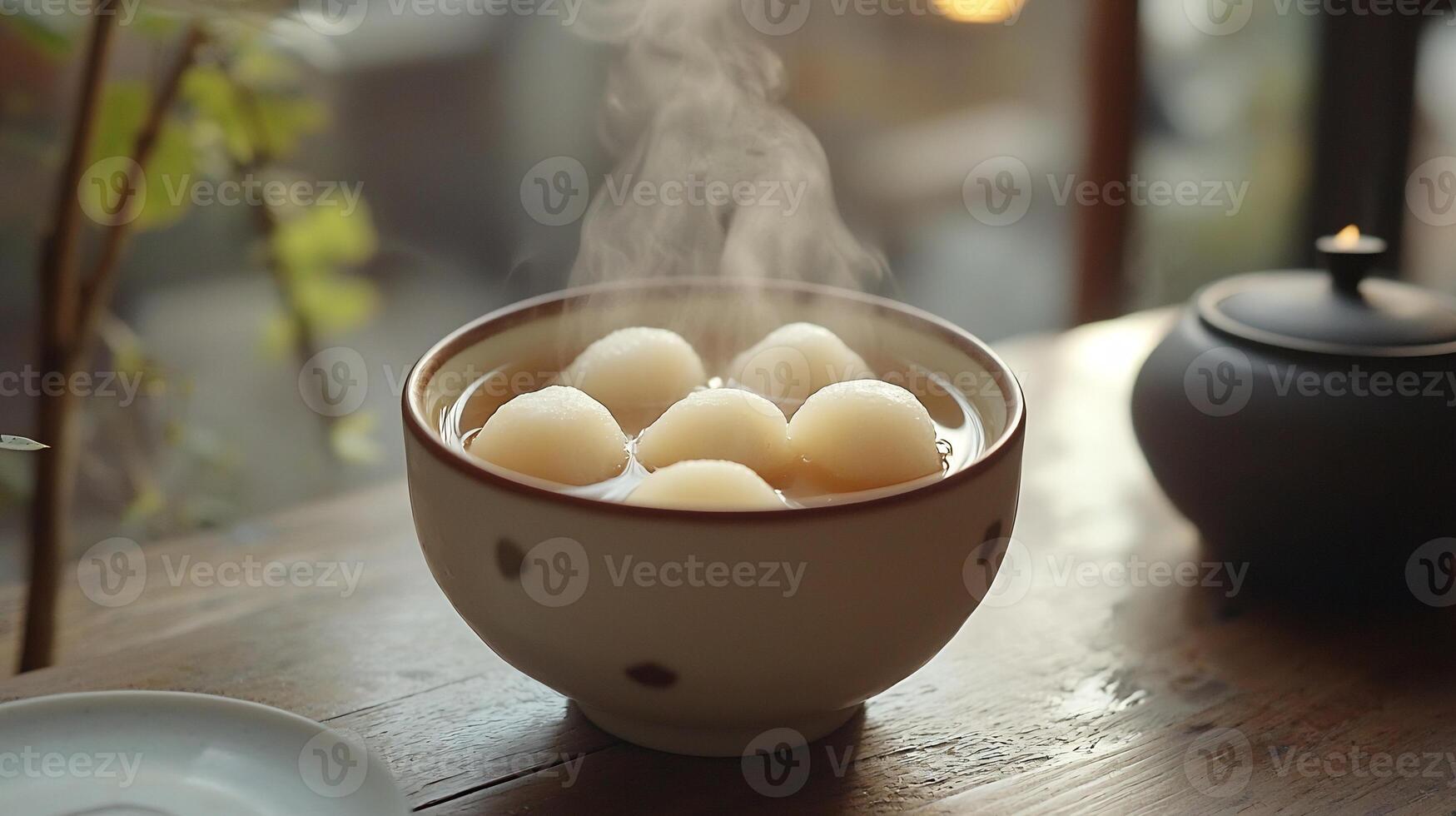 A cup of steaming hot water with some balls in it photo