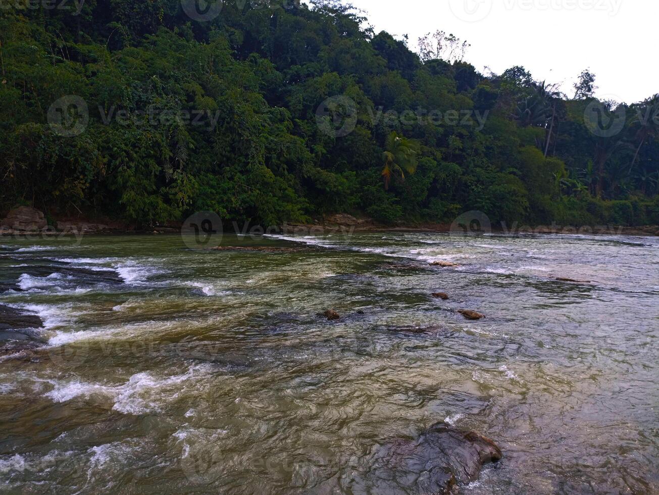 A river with white water and rocks photo
