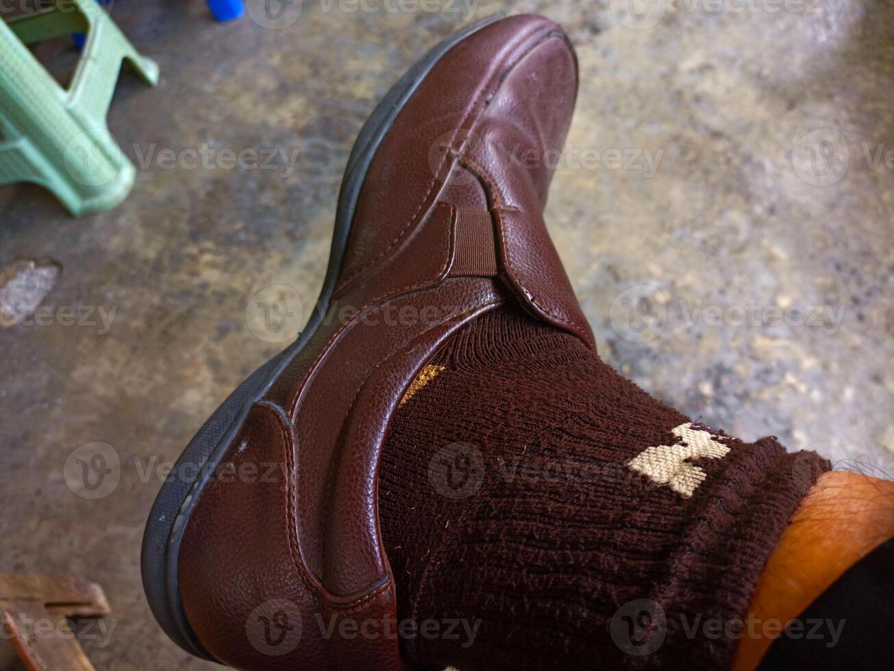 A person wearing a pair of brown shoes photo