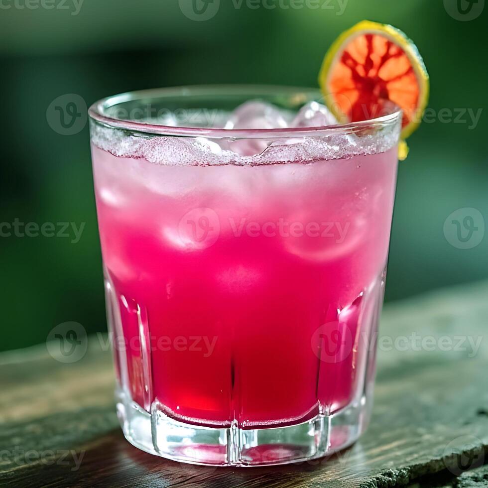 Refreshing pink cocktail with ice and blood orange slice perfect for summer refreshment photo