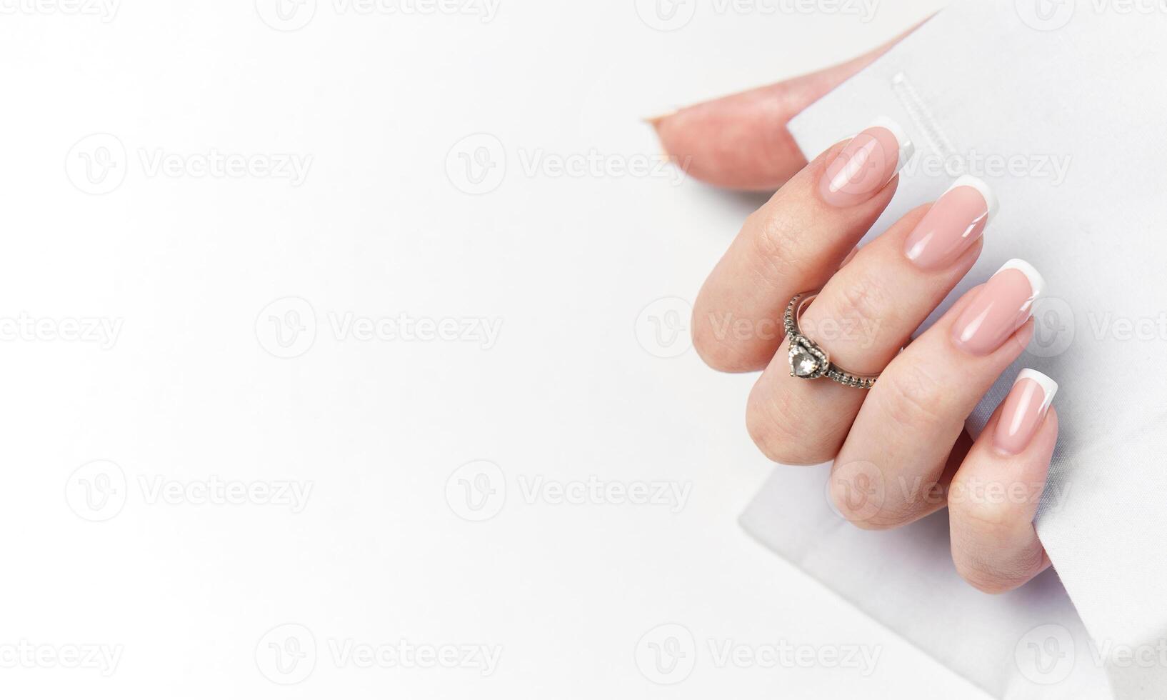 Woman hand showing french manicure photo