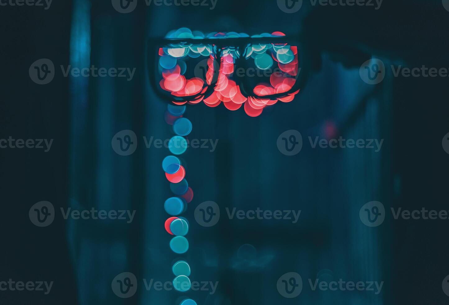 Bokeh lights reflected in eyeglasses at night photo