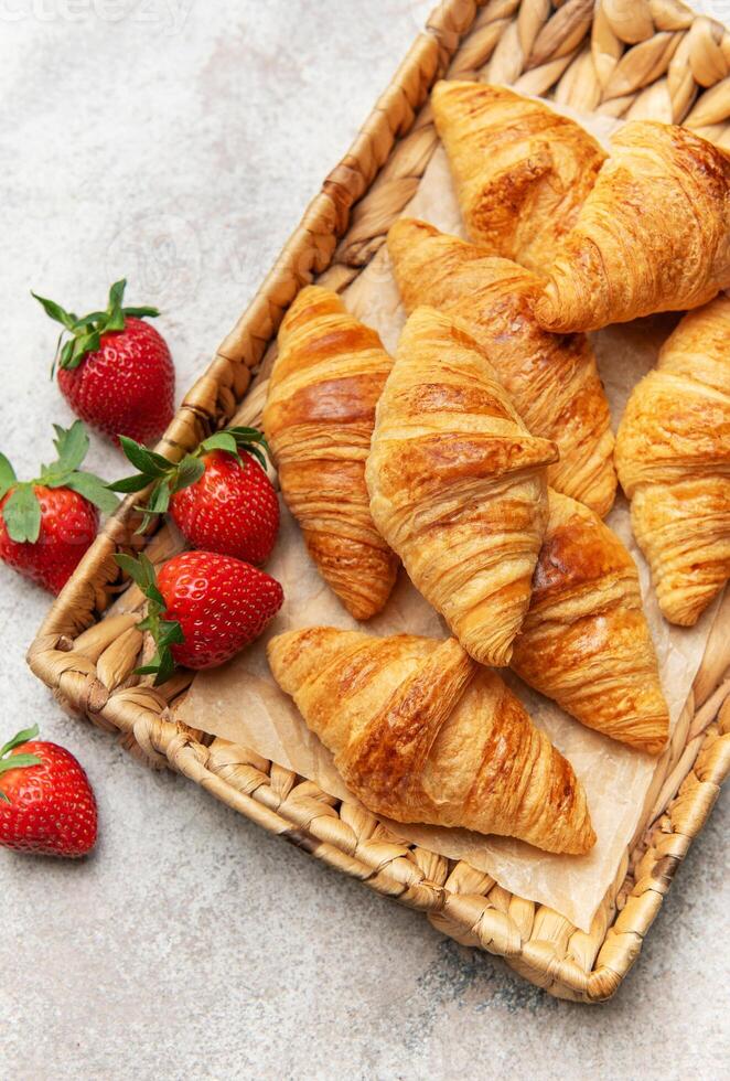 Freshly baked croissants and strawberries creating a delightful breakfast scene photo