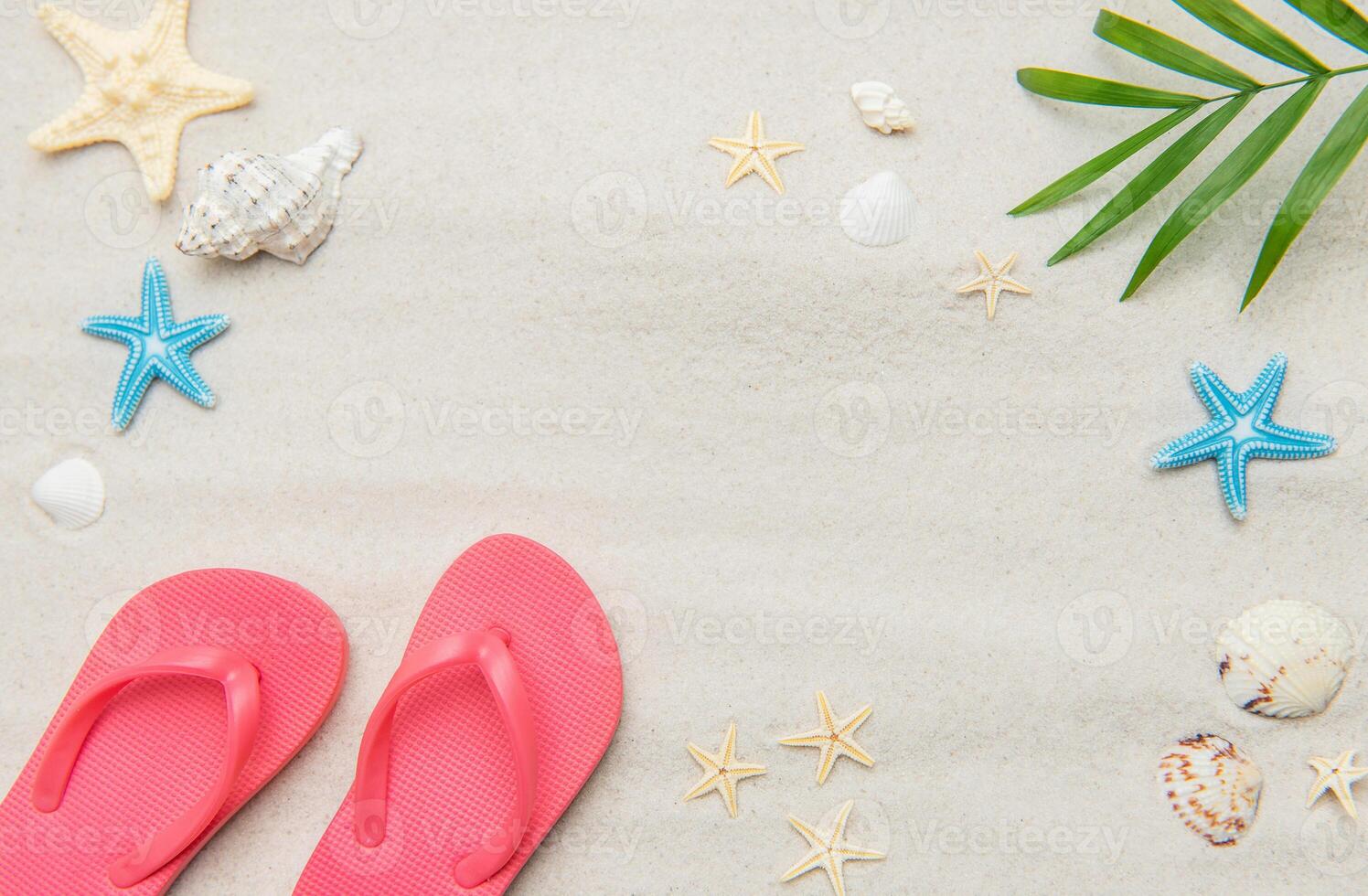 Pink flip flops, seashells, and starfishes creating relaxing summer beach background photo