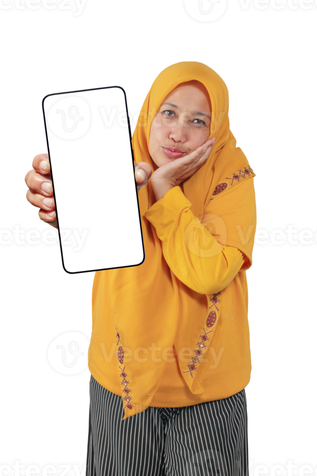 Playful Muslim woman in yellow hijab pouting and holding blank screen smartphone forward png