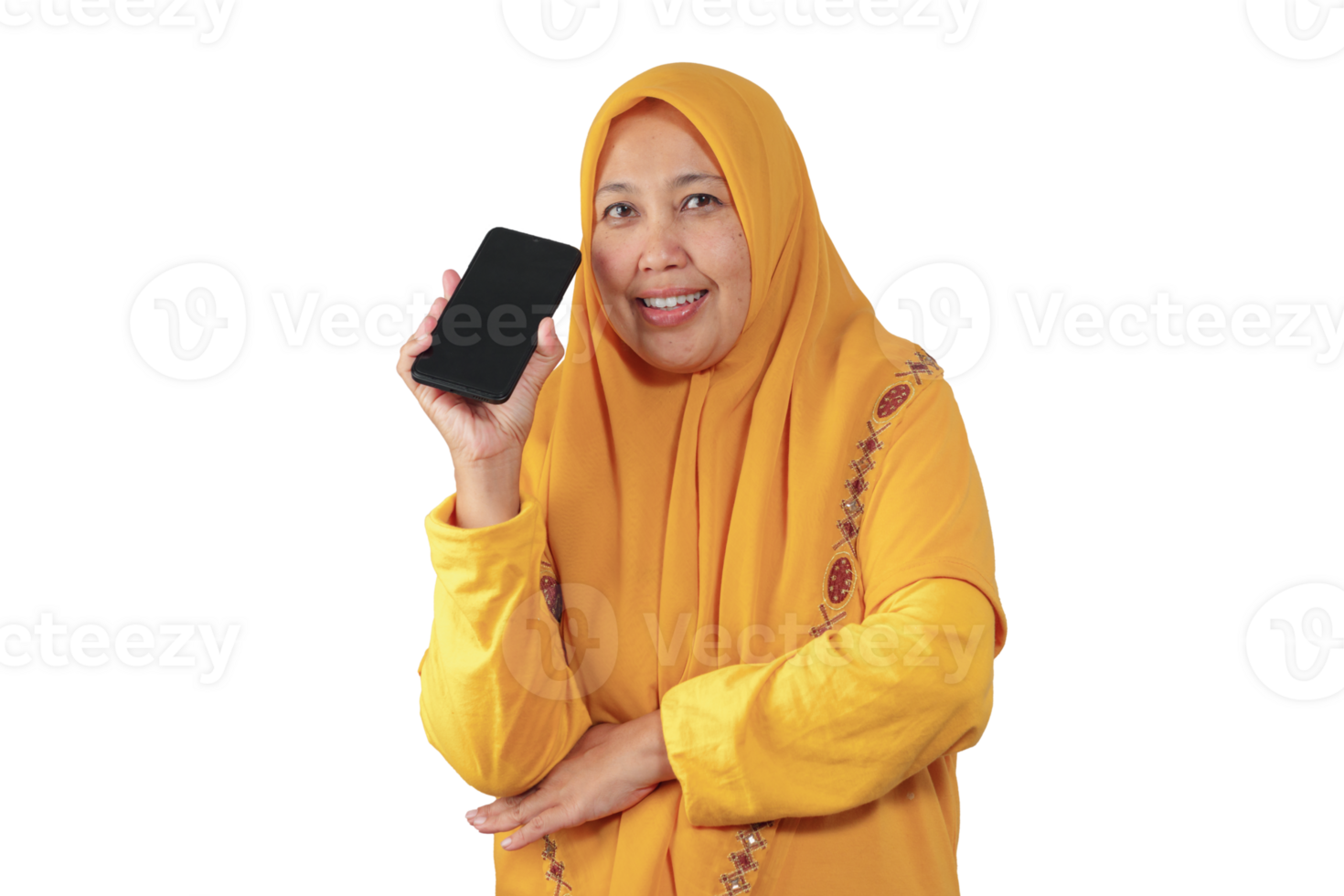 Cheerful Muslim woman in yellow hijab holding black smartphone beside her face and smiling png