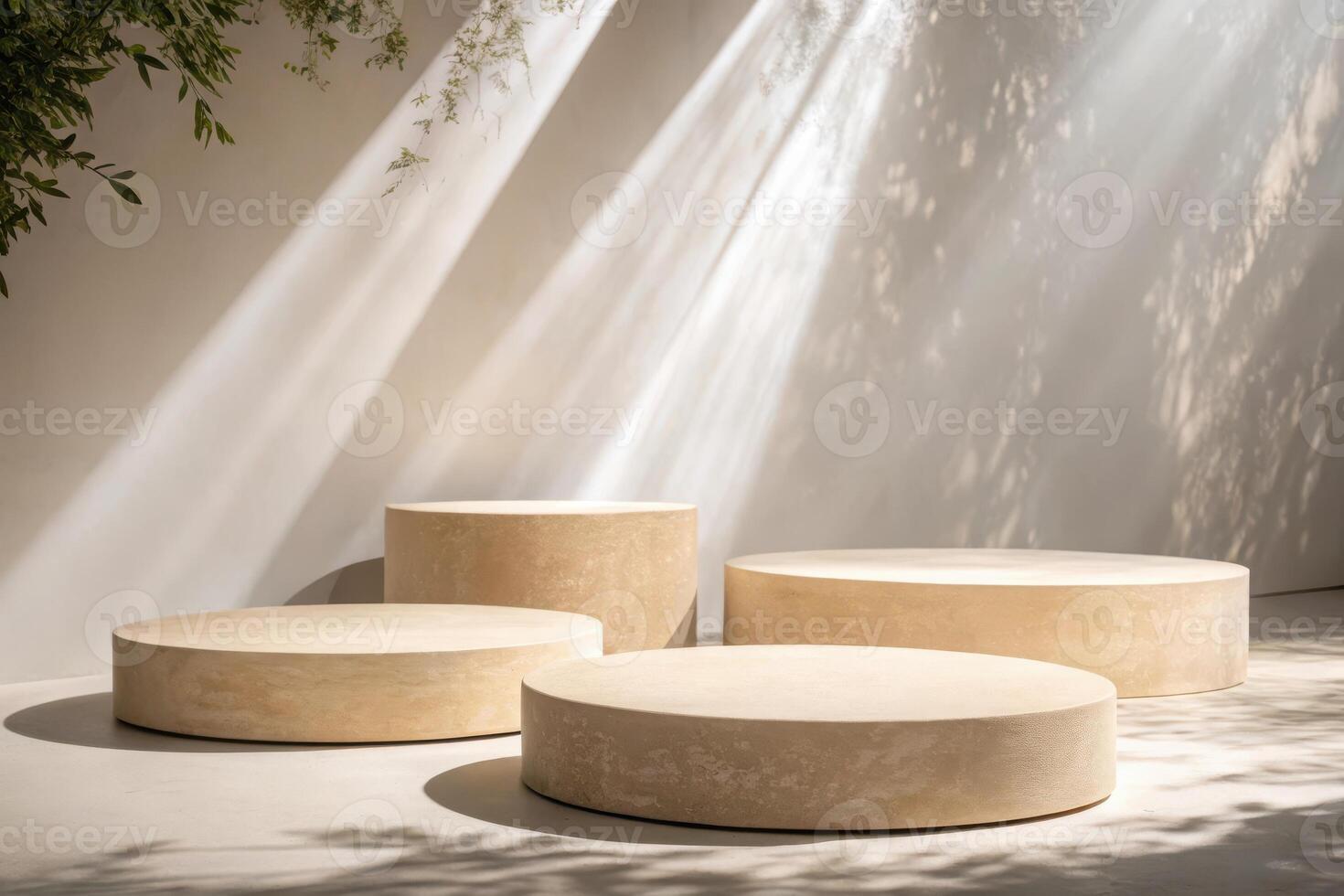 Beige cylindrical display platforms in sunlit room photo