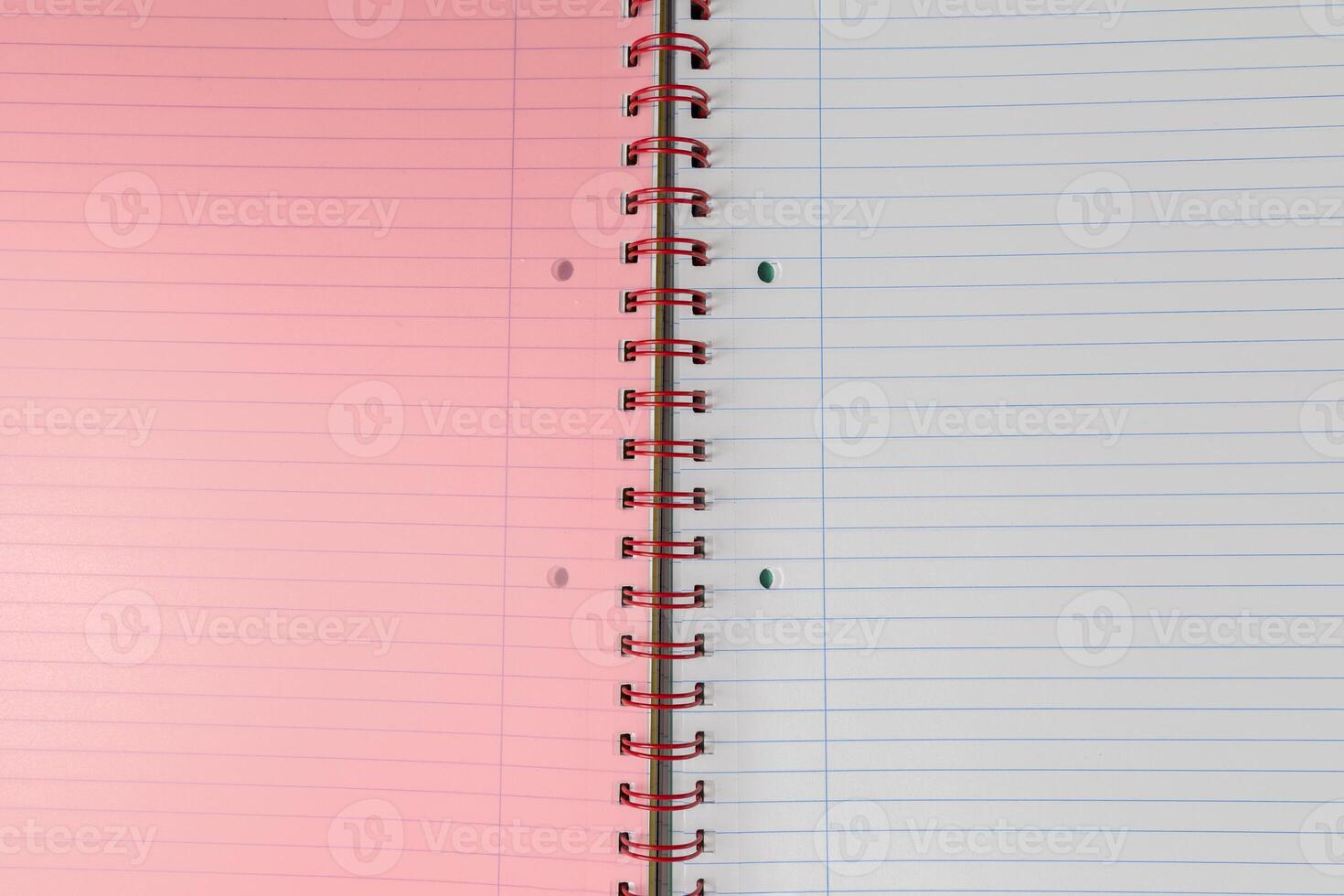 Spiral bound lined notebook with light pink page photo