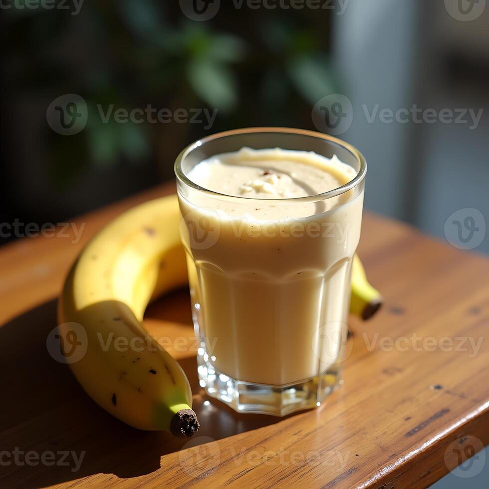Banana Smoothie in Glass with Banana on Wooden Table photo