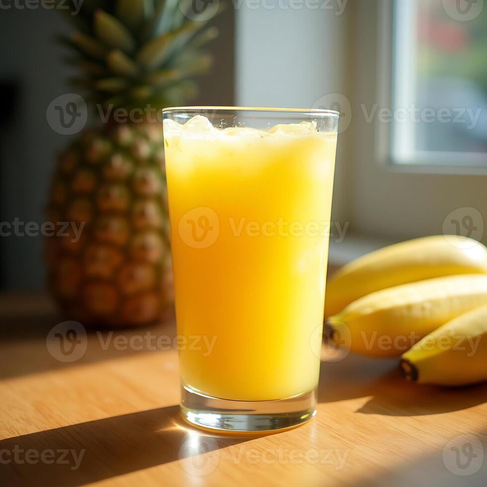Refreshing Pineapple Juice in Glass with Bananas and Pineapple photo