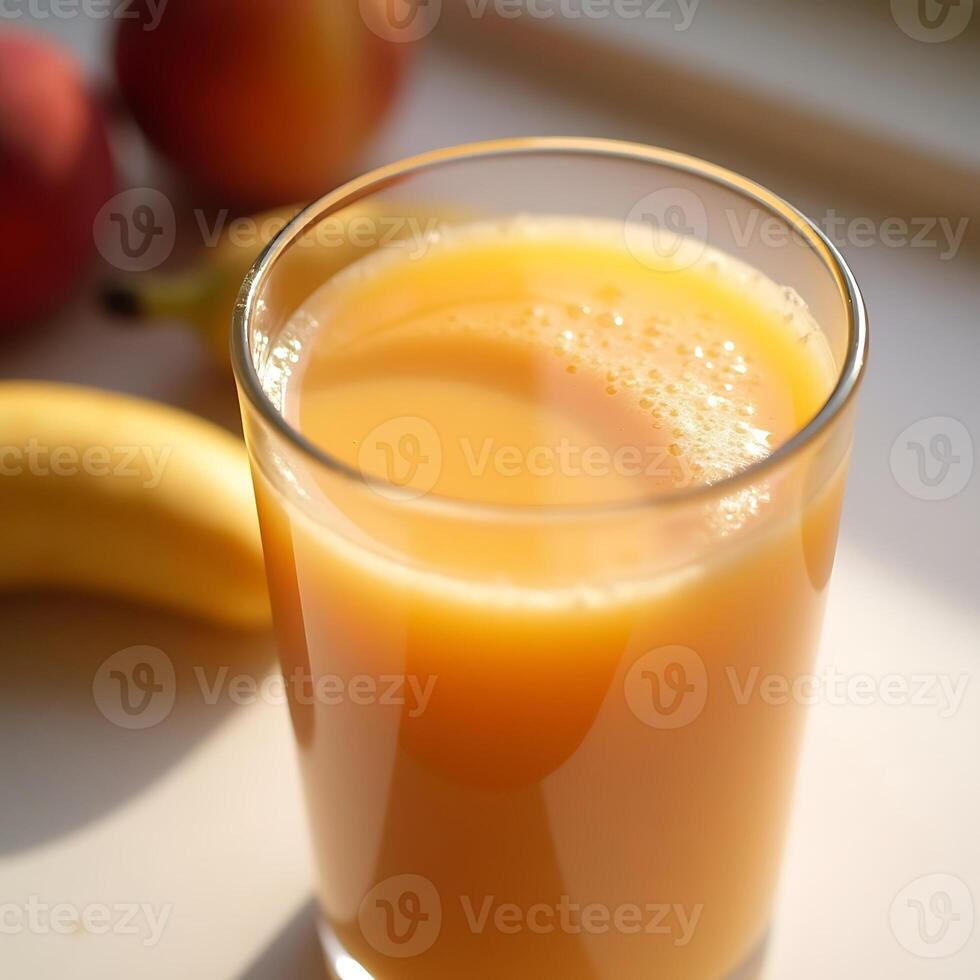 Pouring Fresh Fruit Juice Into Glass with Peaches and Bananas photo